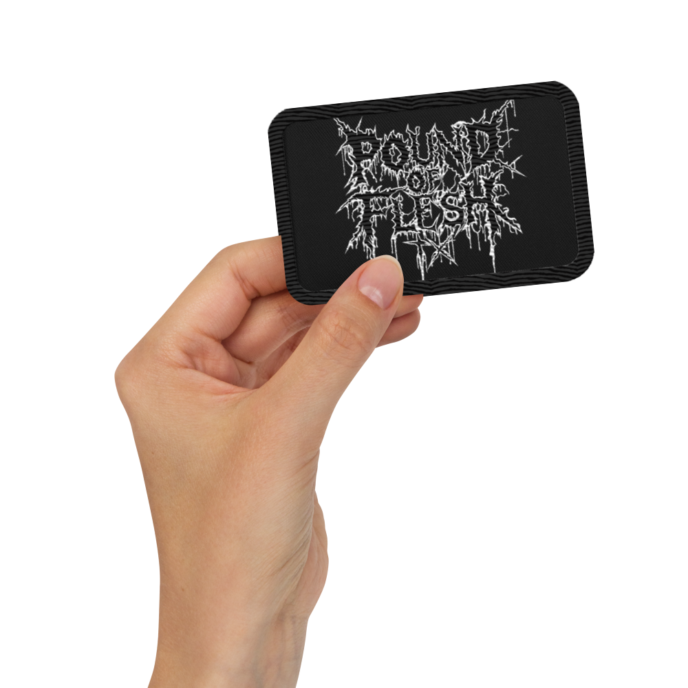 Hand holding a black rectangle patch with th ePound Of Flash TX logo embroidered in white